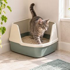 Cat stepping into a corner-shaped litter box